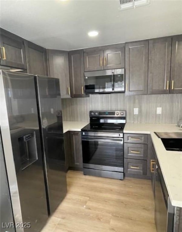 Kitchen featuring appliances with stainless steel