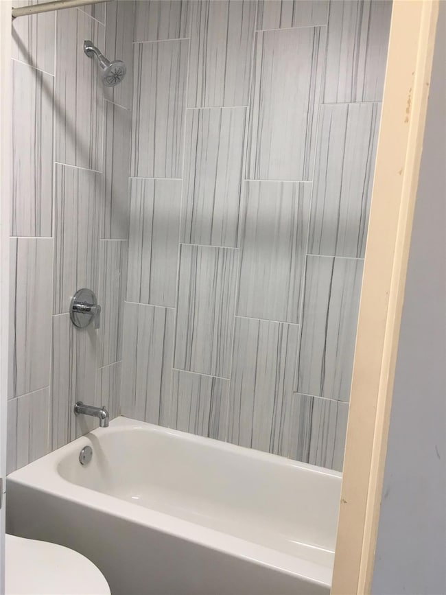 Full bath with shower / bath combination and toil