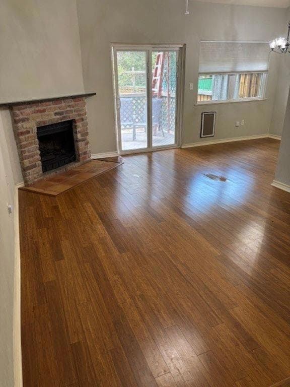 Unfurnished living room featuring wood finished f