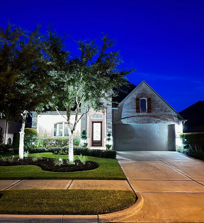 Integrated outdoor lighting illuminates the front