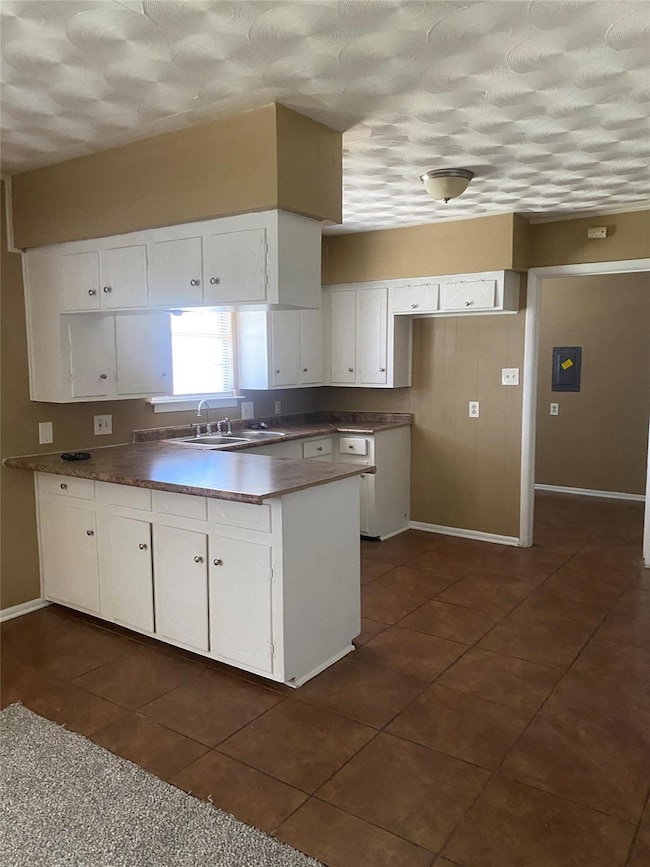 Kitchen featuring a peninsula, white cabinetry, a 