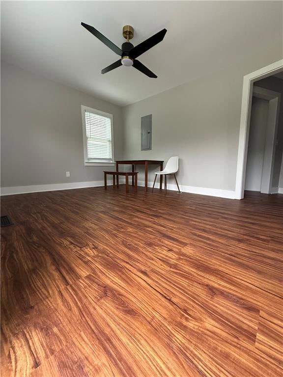 Empty room with dark wood finished floors and electric panel