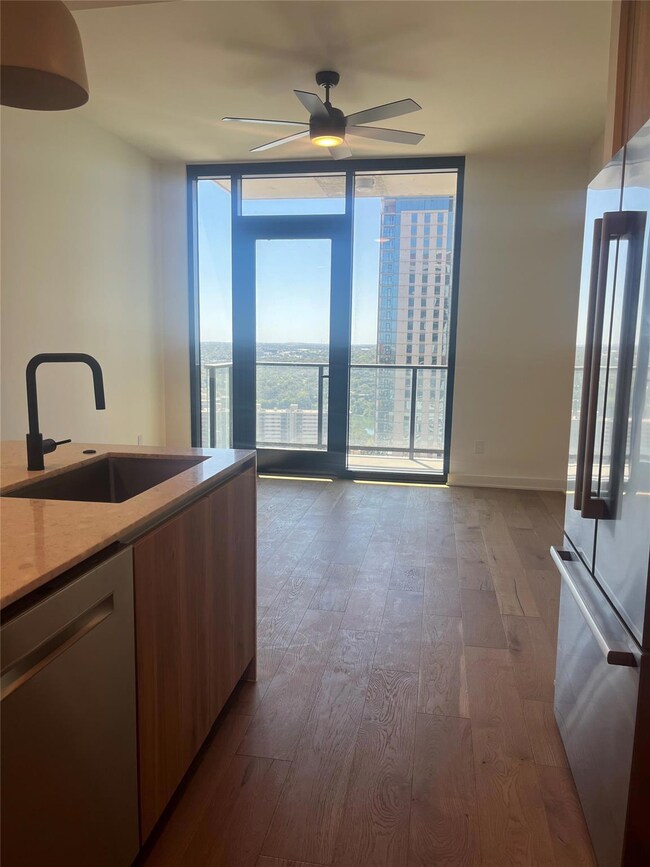 Kitchen featuring freestanding refrigerator, stai