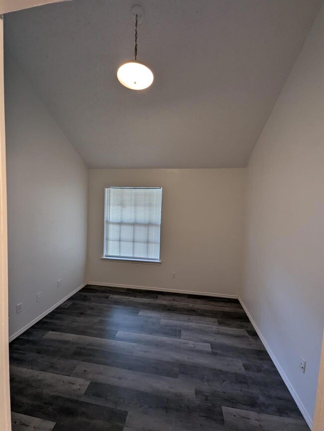 Additional living space featuring dark wood-type f