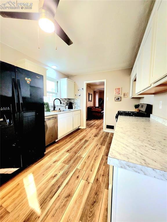 Kitchen featuring a ceiling fan, light wood-type f