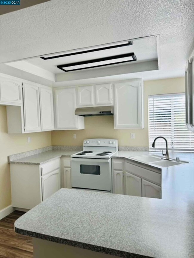 Newly painted, new flooring, new range, updated countertops and cabinets.