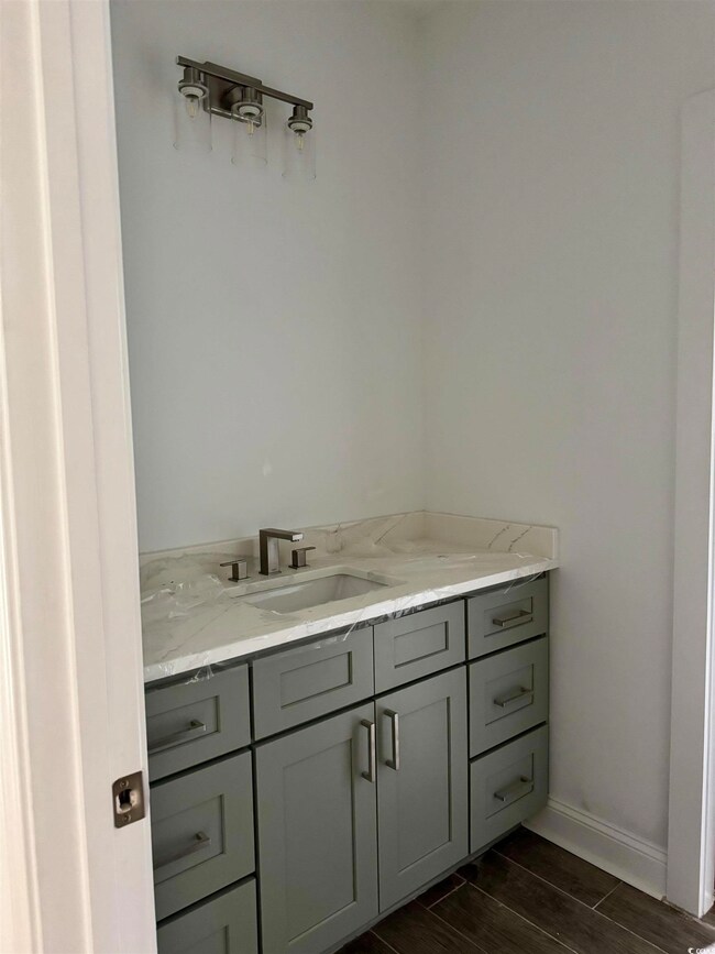 Bathroom with vanity and wood finish floors