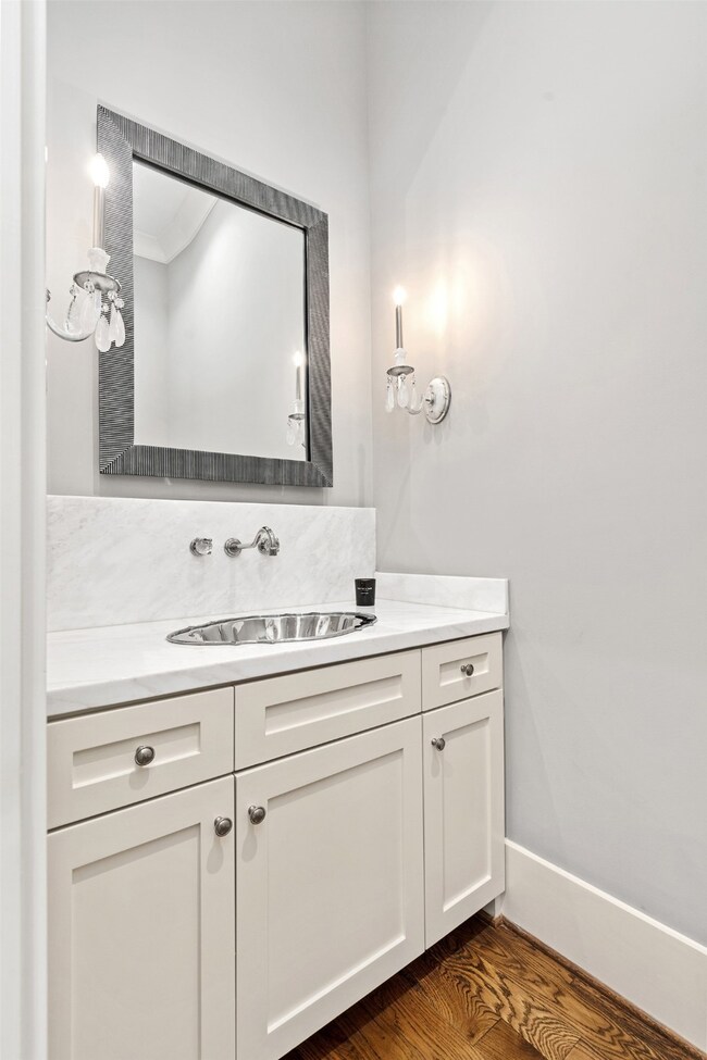 Powder bath located on first floor with marble cou