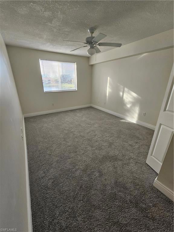 Spare room with carpet floors, a textured ceiling, and ceiling fan