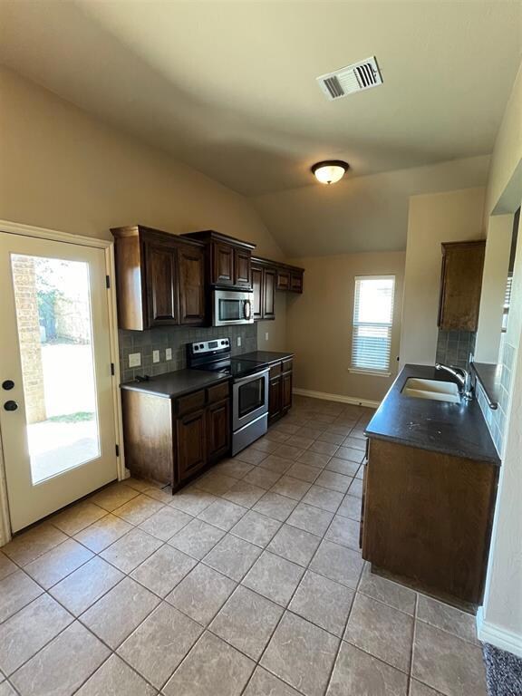 Kitchen featuring light tile patterned flooring, l