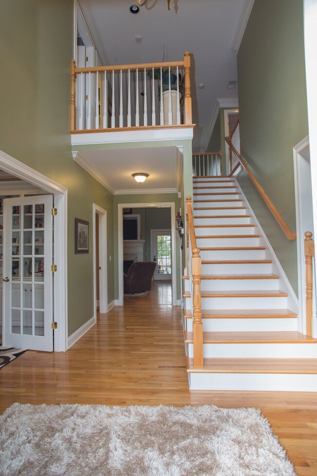 The foyer welcomes you with two story grandeur, refinished wood floors and front staircase.