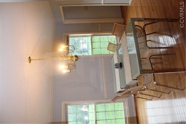 Bright formal dining room with crown ad chair rail