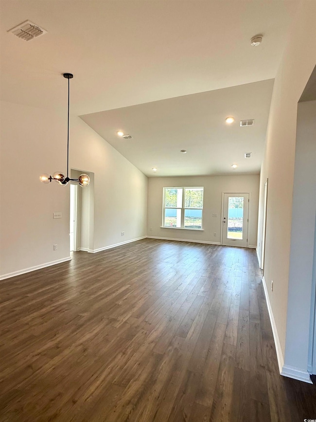 Unfurnished living room with baseboards, dark wood