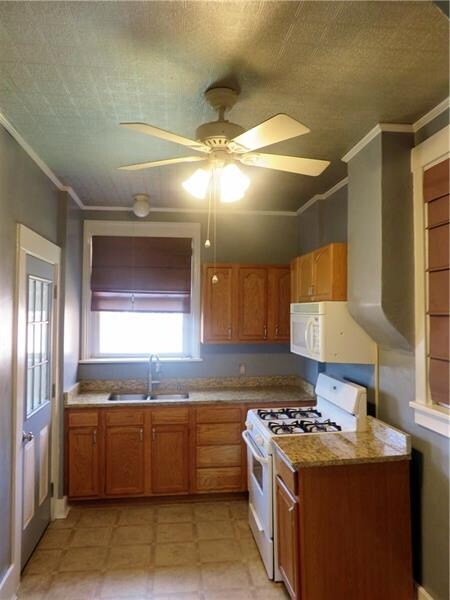 Kitchen leads to enclosed porch.