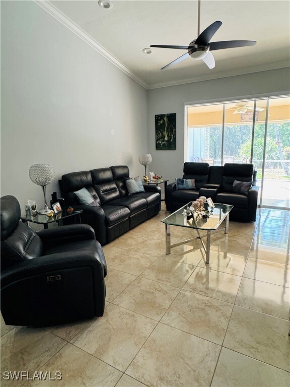 Living area with ornamental molding, a ceiling fan