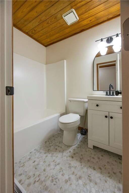 Main floor bathroom with vanity, wood ceiling, and
