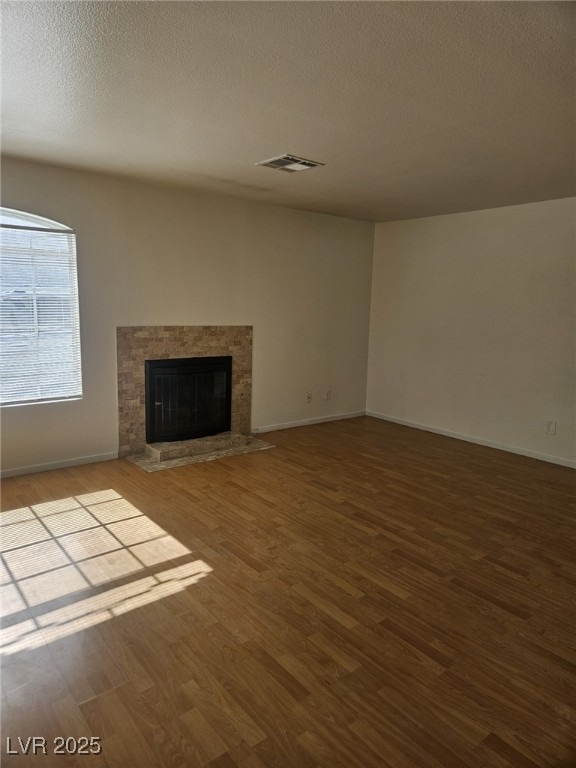 Unfurnished living room featuring wood finished fl