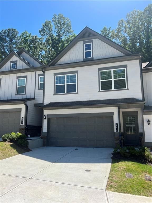 Craftsman house with an attached garage and concrete driveway