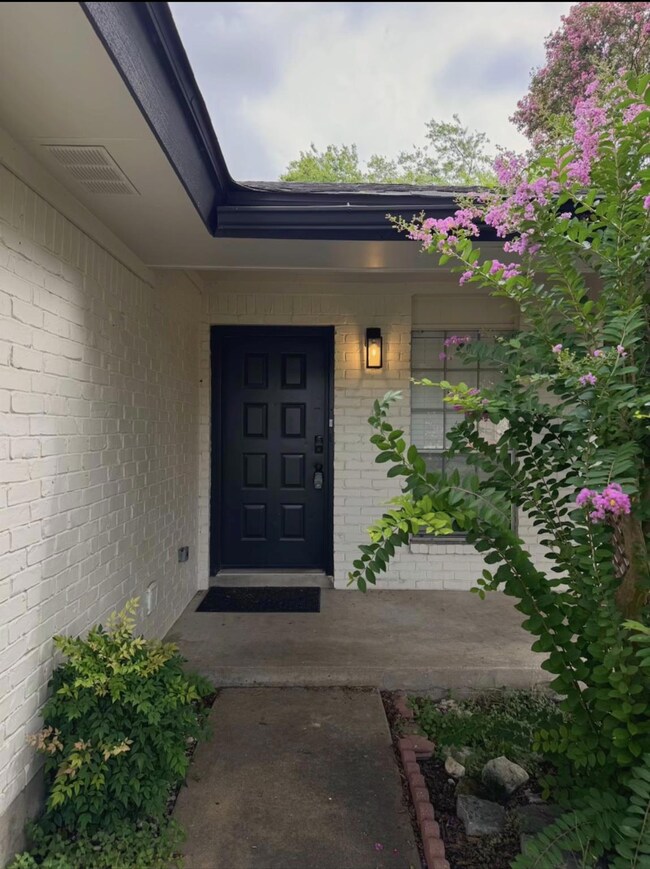 Doorway to property featuring brick siding