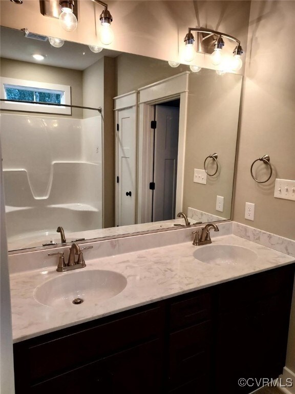 Bathroom with vanity and walk in shower