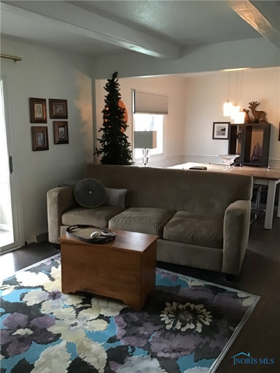 LR opens to bright DR with same new flooring