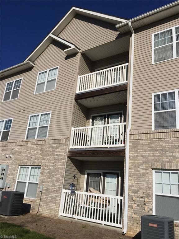 Rear view of building and 3rd floor balcony