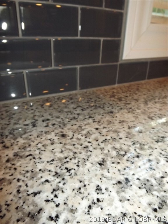 Granite Counter tops with dark grey subway tile ba