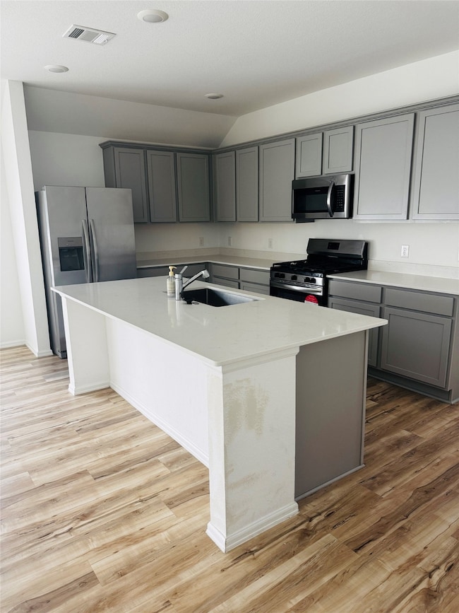 Modern kitchen with gray cabinets, stainless steel