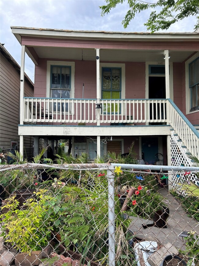 Front house. There is a walkway to the left going