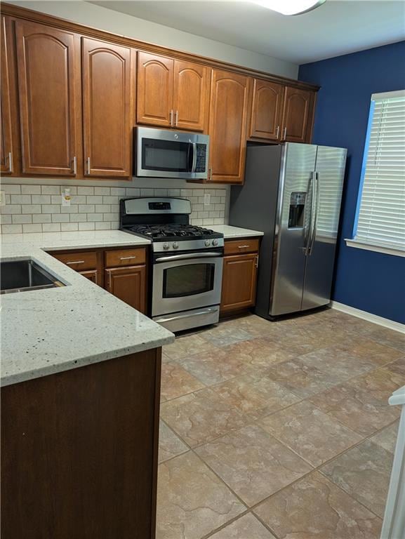Kitchen with gas stove and granite countertop.