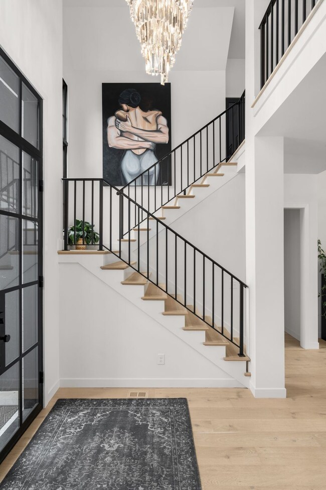 Designer Restoration Hardware light fixture above the stairs illuminates the foyer, setting the stage for the exquisite features that await