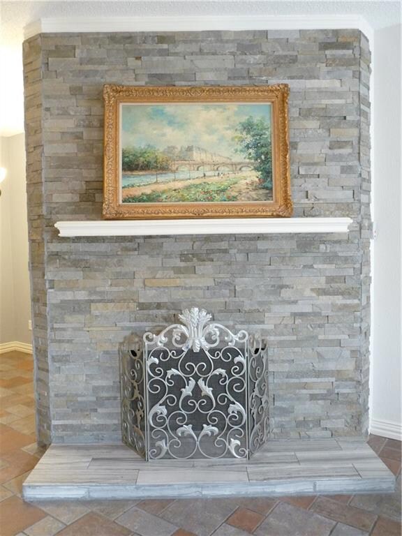 Floor to ceiling quartz stacked stone fireplace wi