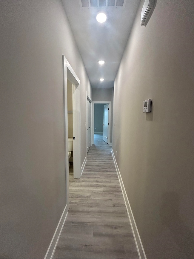 Hallway featuring light wood-style floors and recessed lighting
