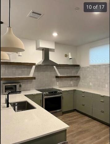 Kitchen with stainless steel appliances, open she