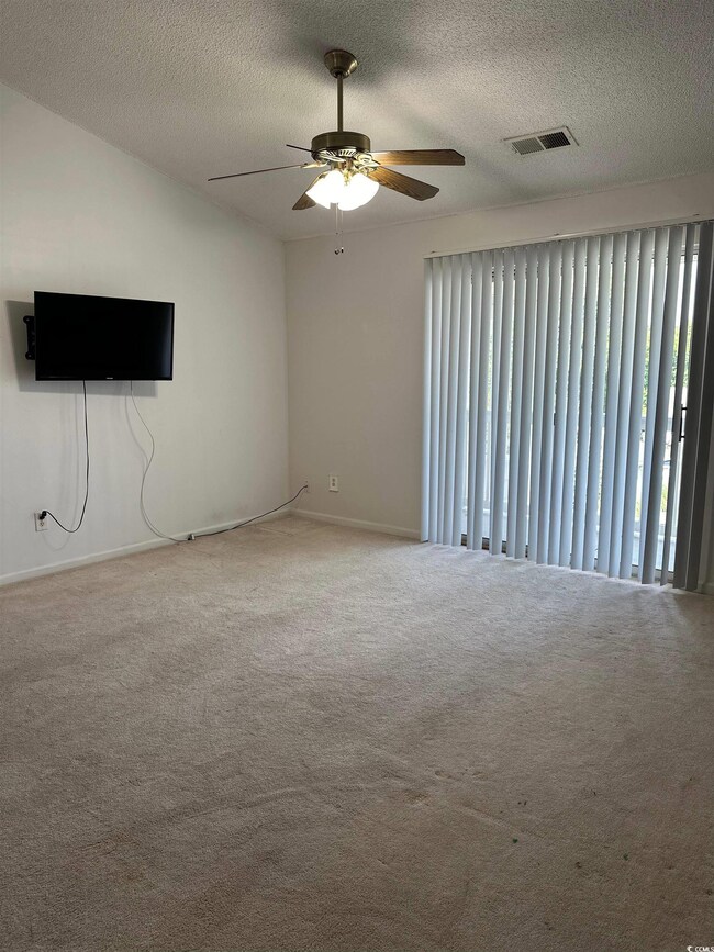 Unfurnished room featuring carpet flooring, a text