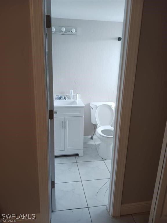 Bathroom featuring vanity and toilet
