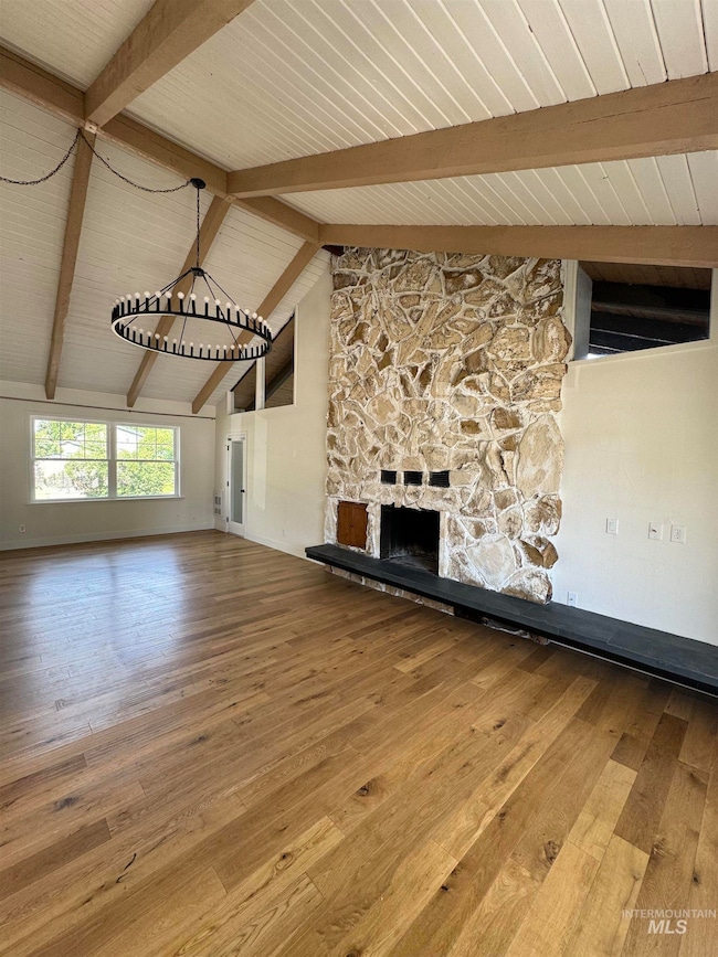 Unfurnished living room with hardwood / wood-style floors and wood ceiling