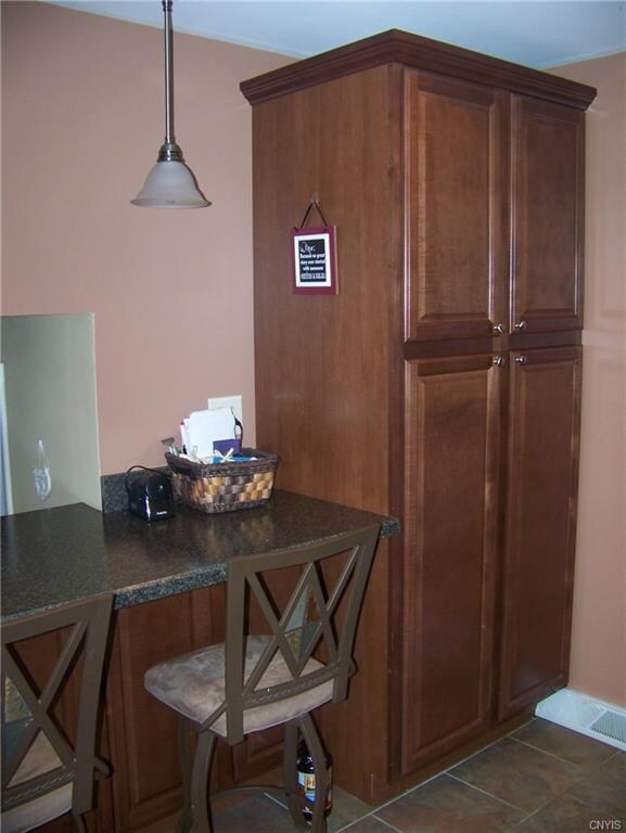 More cabinet space next to the eat in bar.