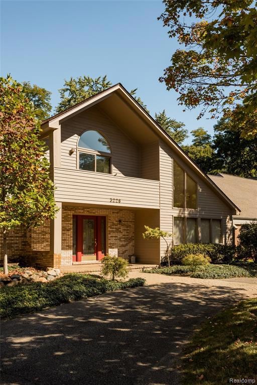 View of front of home featuring brick siding