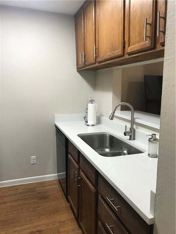 Kitchen featuring dishwasher, light countertops, 