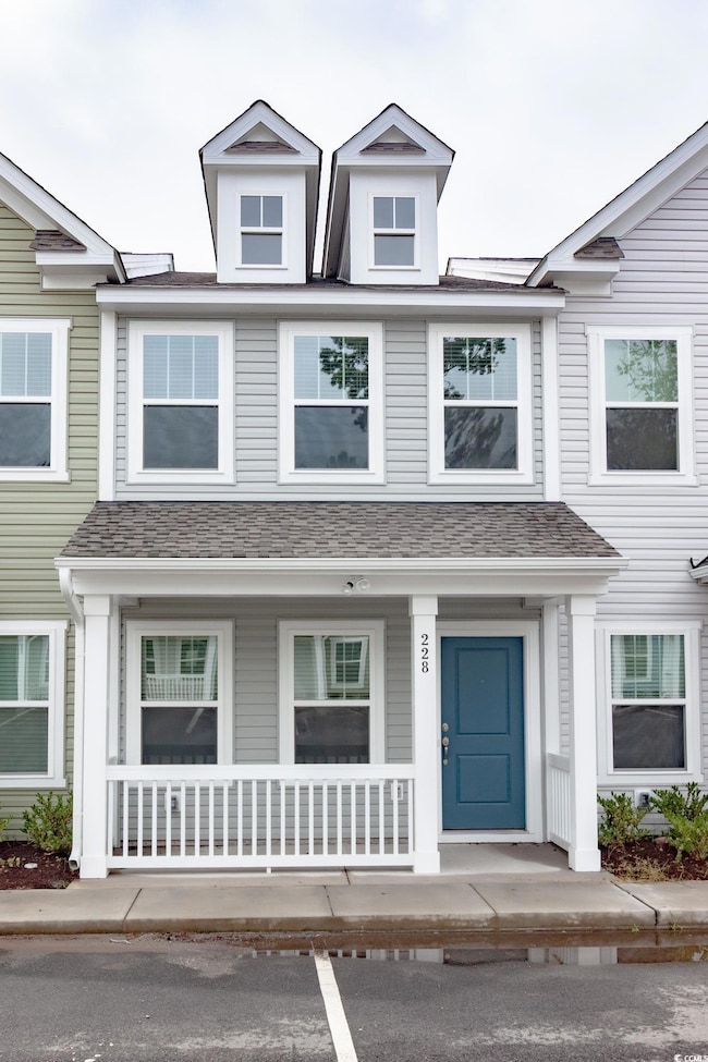 Townhome / multi-family property with covered porch