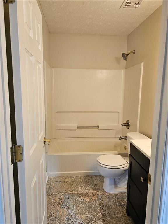 Bathroom with vanity, toilet, bathtub / shower combination, and a textured ceiling