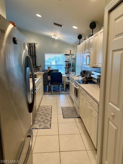 Kitchen featuring light tile patterned floors, lof