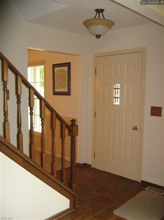 Spacious Foyer with hardwood parquet floor welcome