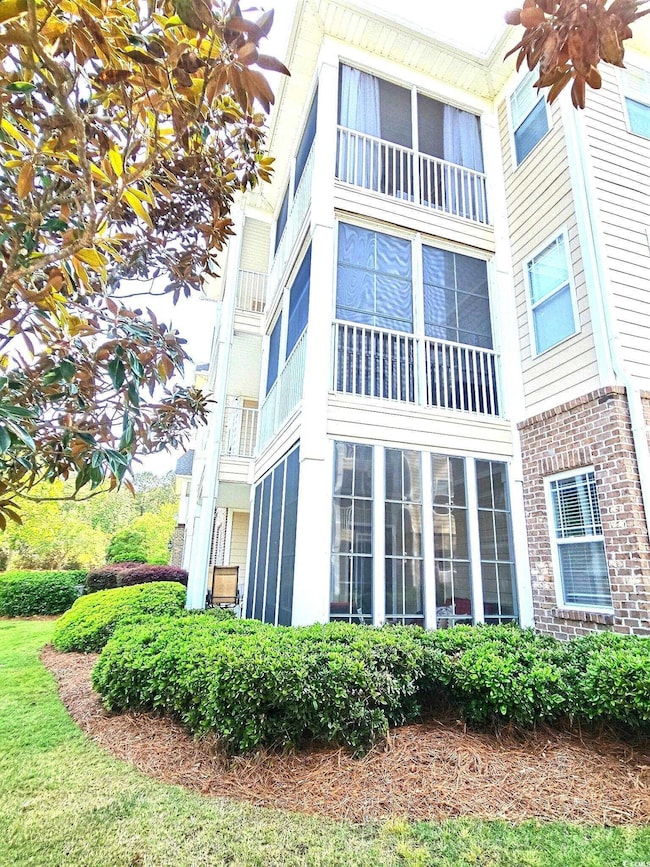 View of property exterior featuring brick siding