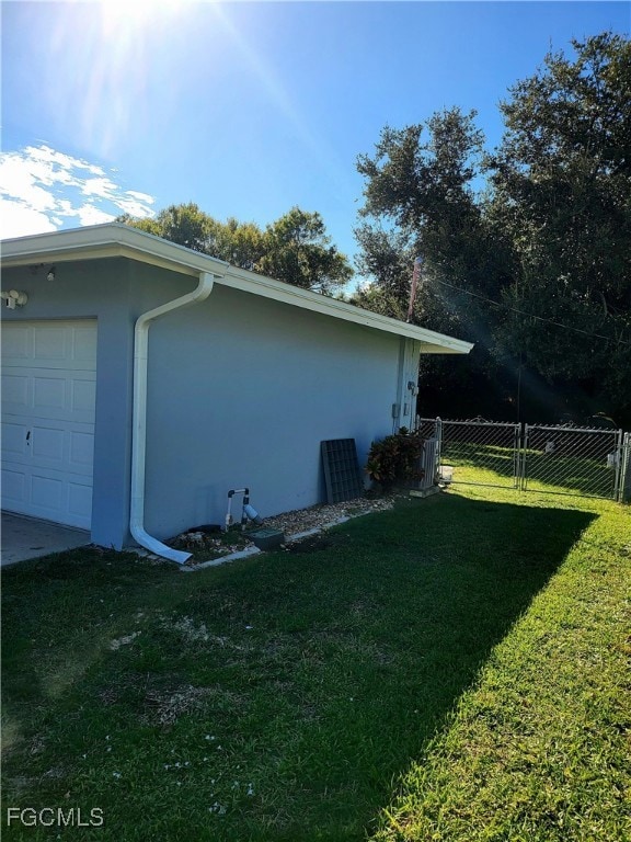 View of property exterior with a garage and stucco siding