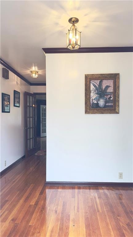 Spare room featuring baseboards, wood finished flo