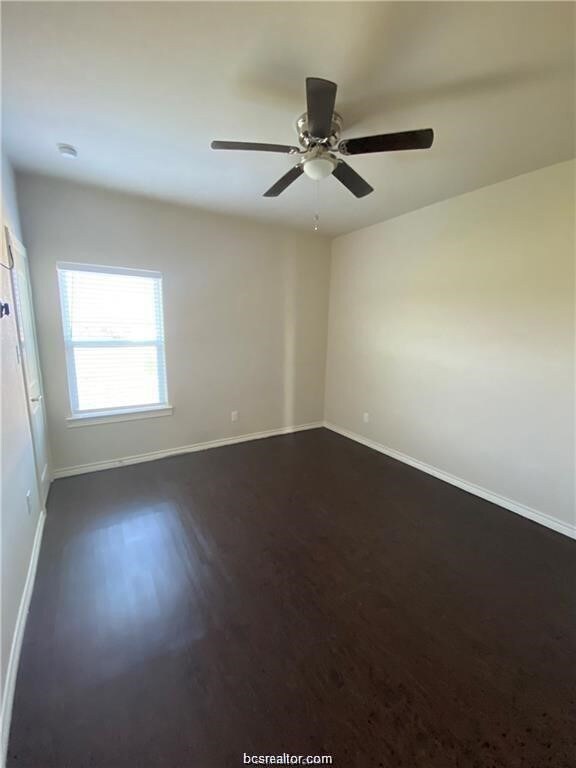 Unfurnished room featuring dark wood-type flooring