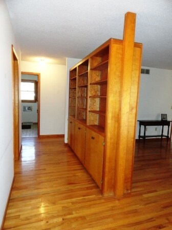 Hallway created by shelving divider