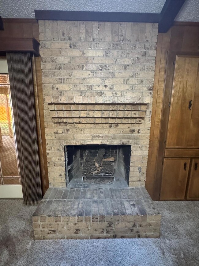 Interior details featuring a fireplace, carpet, an